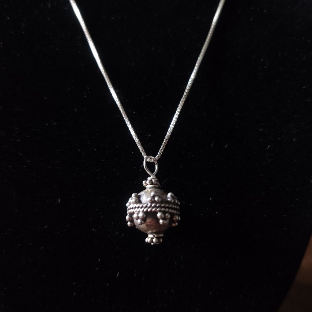 Silver necklace with decorative pendant